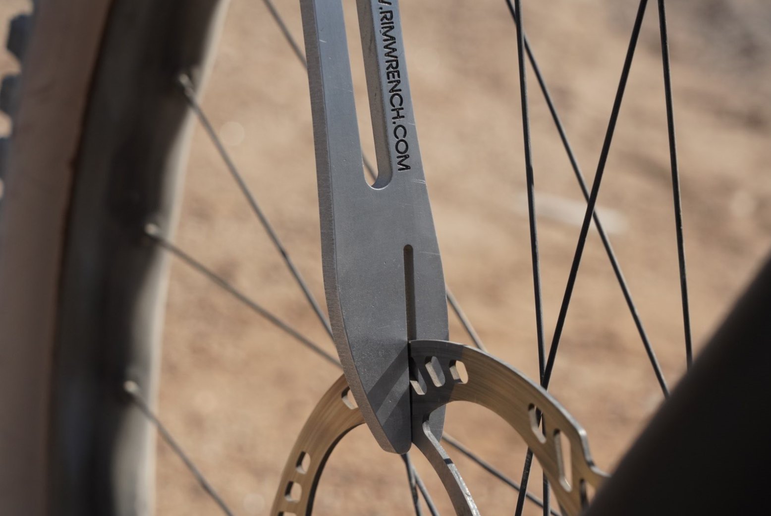 RimWrench disc brake truing fork straddling a bicycle disc brake rotor for straightening