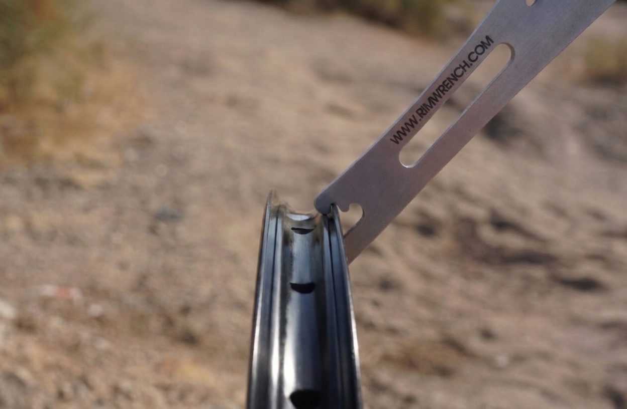 RimWrench leveraging a dent out of an aluminum bicycle rim